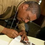 Ron Lacks signing a book